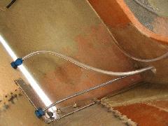 View of the space between left half of firewall and canard lift bulkhead showing lower firewall angle, throttle cable and fuel tubing to bulkhead fitting IMG_0412.jpg